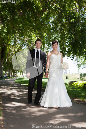 Image of Newlywed Young Couple Holding Hands