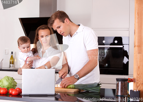 Image of Family in Kitchen Preparing Meal