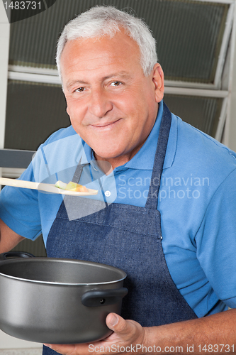 Image of Man Tasting Food From Spoon