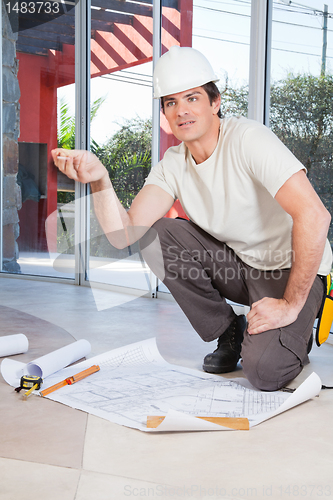 Image of Construction worker with project paper