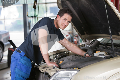 Image of Mechanic Portrait Working on Car