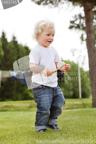 Image of Boy holding gardening tool