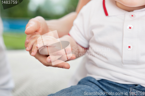 Image of Mother holding child's hand