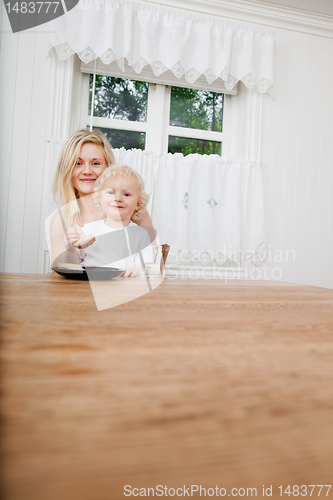 Image of Smiling baby boy eating bread