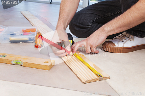 Image of Man marking on plywood