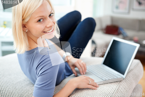 Image of Portrait of woman using laptop