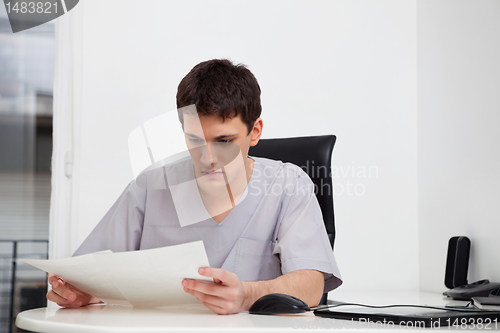 Image of Doctor reading reports