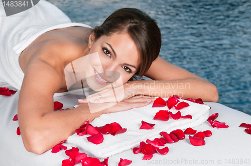 Image of Woman lying on bed in spa