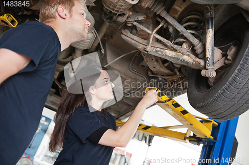 Image of Two Mechanics Discussing Problem