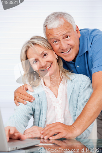 Image of Happy Couple Using Laptop