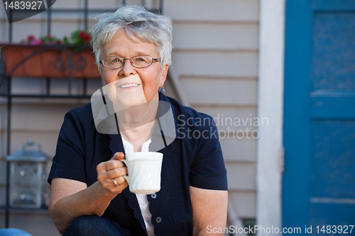 Image of Senior woman having tea