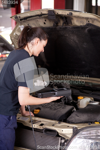 Image of Woman Mechanic with Engine Diagnostics Tool