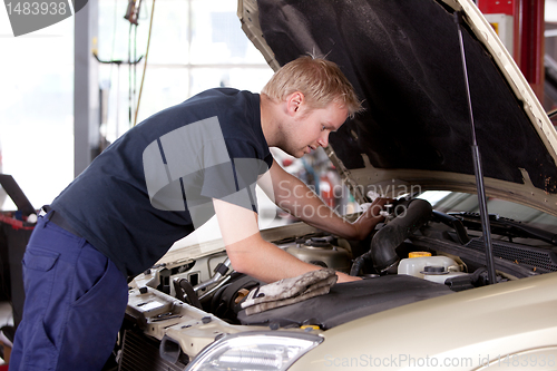 Image of Mechanic Fixing Car