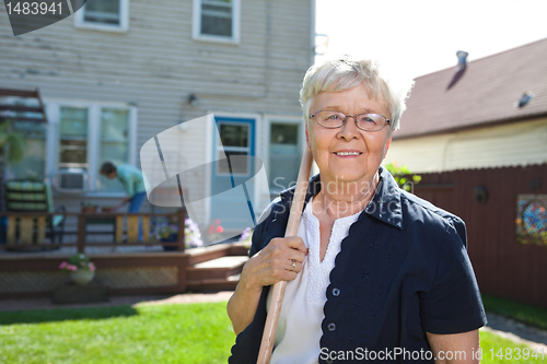 Image of Senior woman holding gardening tool