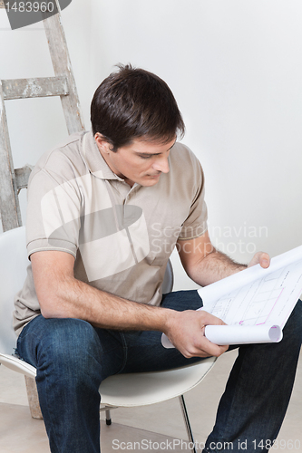 Image of Man looking at blueprint