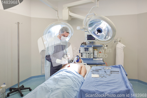 Image of Young doctor performing operation