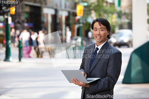 Image of Business Man Portrait Outdoor with Laptop