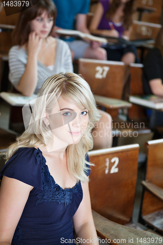 Image of Portrait of college girl sitting in auditorium