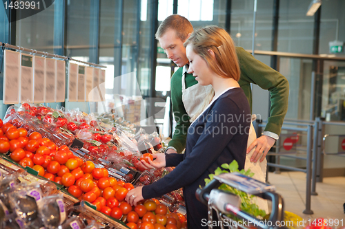 Image of Woman buying tomatoes