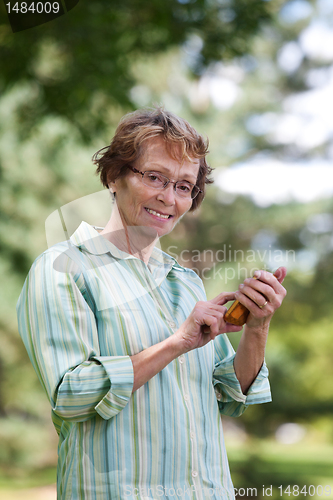 Image of Senior Woman Writing Text message