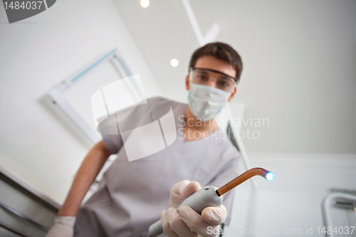 Image of Dentist holding ultraviolet light