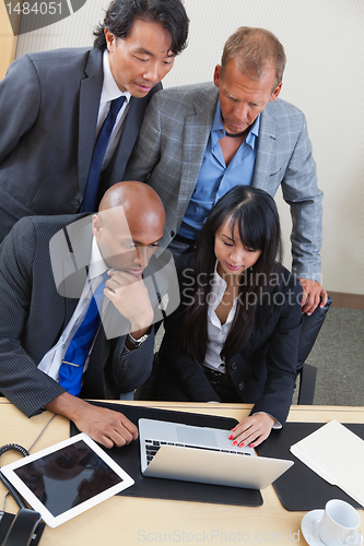 Image of Business team working on laptop together