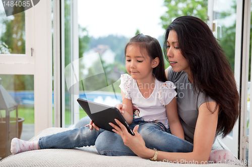 Image of Mother and daughter with digital tablet