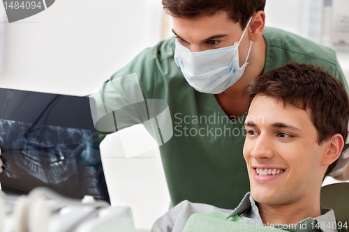 Image of Patient looking at his tooth x-ray