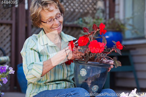 Image of Woman looking at flower pot