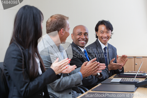 Image of Professionals applauding during a business meeting
