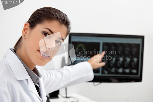Image of Dentist showing teeth x-ray on screen