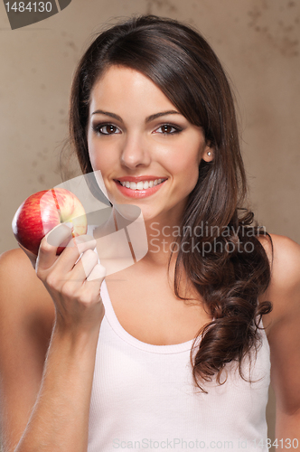 Image of Smiling woman holding apple