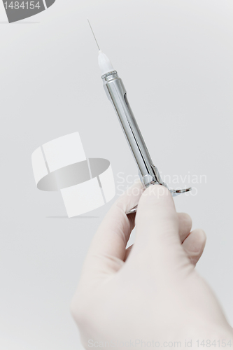 Image of Close-up of hand holding needle