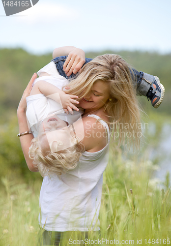 Image of Mother and Son Playing in Meadow