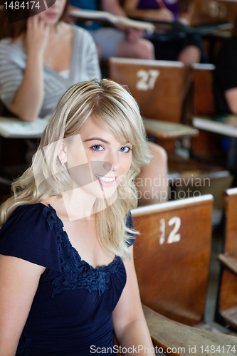 Image of Portrait of college girl sitting in auditorium