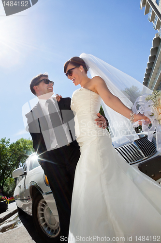 Image of Happy Wedding Couple with Limo