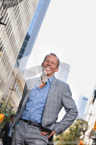Image of Businessman standing with buildings in background