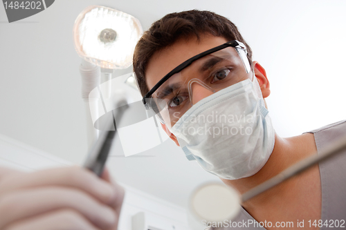 Image of Dentist holding dental tool