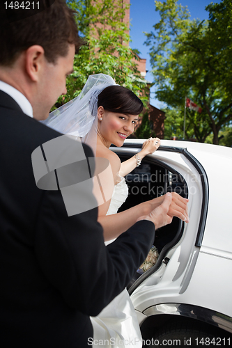 Image of Bride and Groom with Limo
