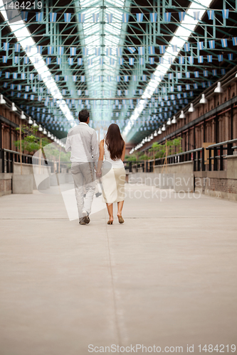 Image of Couple Walking Holding Hands