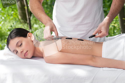 Image of Woman getting hot stone massage
