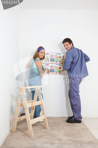 Image of Couple Decorating Baby Room