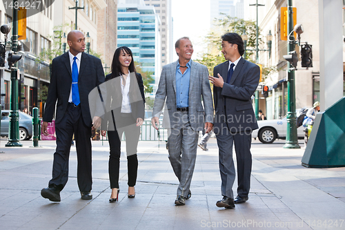 Image of Business people walking together on street