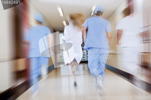 Image of Doctor and nurse running in passageway