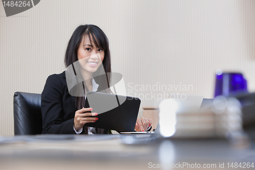 Image of Businesswoman working on digital tablet