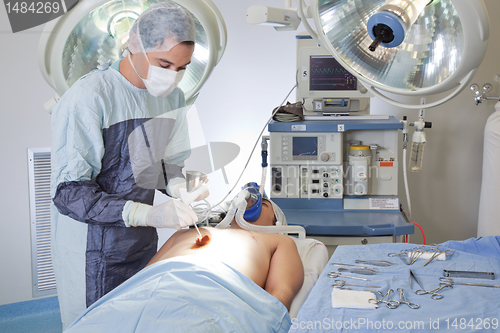 Image of Male doctor performing operation