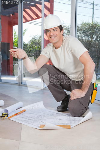 Image of Construction worker with blueprint