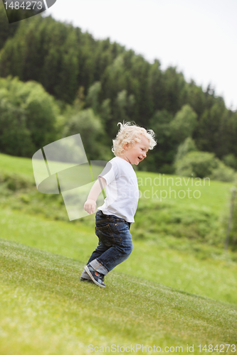 Image of Toddler Boy Walking Alone in Garden