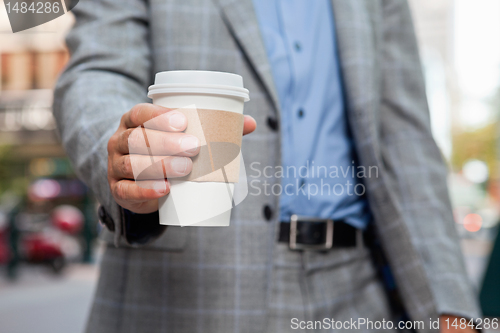 Image of Businessman holding disposable cup