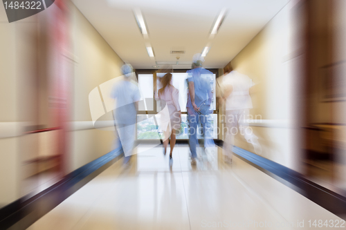 Image of Surgeon and nurse running in passageway
